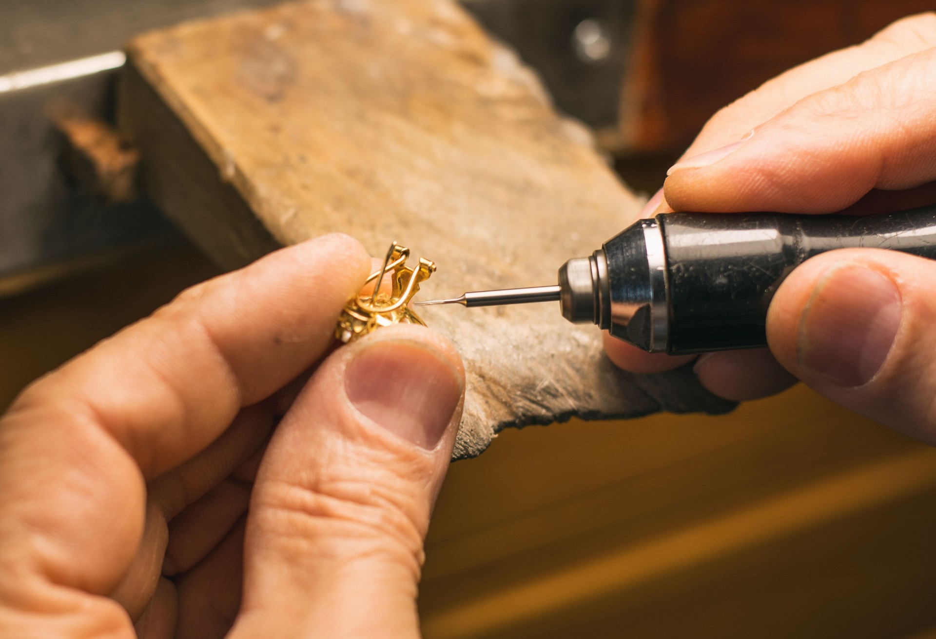 Hands of a craftsman jeweler working on jewelry. Goldsmith. Goldsmith workshop jewels and articles of work value