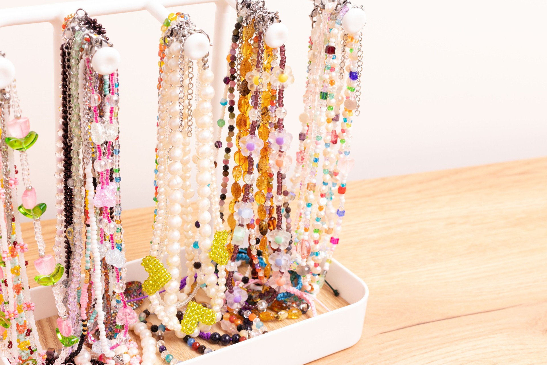 Different handcraft chains of beads, pearls and natural stones.